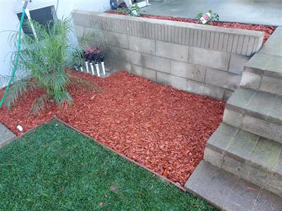 Fresh mulch around planting and irrigation valves beside the lawn