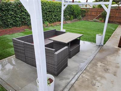 New sod lawn beyond a covered patio seating area